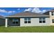 Exterior rear of home with an outdoor patio and green grass lawn at 1827 Silverbell Loop, Haines City, FL 33844