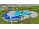 Aerial shot showcasing a community pool with lounge chairs, shaded areas, and lush landscaping for relaxation at 1827 Silverbell Loop, Haines City, FL 33844