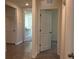 Hallway with tile floors and open doorway leading to an adjacent room at 1827 Silverbell Loop, Haines City, FL 33844