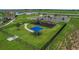 Aerial view of a community playground featuring play structures, swings, and a picnic shelter for residents at 1827 Silverbell Loop, Haines City, FL 33844