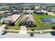 This aerial view showcases the home, landscaping, nearby pond, and community at 194 Aidans Lndg, Haines City, FL 33844