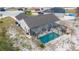 Aerial view of the home highlighting the screened-in pool, landscaping, and outdoor living space at 2038 Lily Pl, Kissimmee, FL 34759