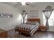 Bedroom with a wooden bed frame, decorative curtains, and natural light from the windows at 2038 Lily Pl, Kissimmee, FL 34759