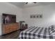 Cozy bedroom featuring a TV, dresser, and reading chair with plaid-patterned bedding at 2038 Lily Pl, Kissimmee, FL 34759