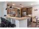 Well-lit kitchen boasts a breakfast bar, pendant lights, stainless steel appliances, and modern gray cabinetry at 2038 Lily Pl, Kissimmee, FL 34759