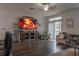 Comfortable living room featuring a large screen TV, a cozy armchair, and a decorative fireplace at 2038 Lily Pl, Kissimmee, FL 34759