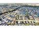 Wide aerial shot of a residential neighborhood featuring a lake with fountain and homes with screened pools at 226 Bailey Cir, Davenport, FL 33897