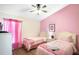 Charming bedroom with two twin beds, pink walls, and a bright, cheerful atmosphere at 226 Bailey Cir, Davenport, FL 33897