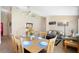 Well-lit dining room next to living space with a wooden table, chairs, and tiled floors at 226 Bailey Cir, Davenport, FL 33897