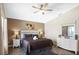 Spacious bedroom featuring a king-sized bed, ceiling fan, and a neutral color palette at 226 Bailey Cir, Davenport, FL 33897