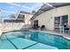 This screened in pool is surrounded by ample seating, offering relaxation with seamless indoor-outdoor transitions at 226 Bailey Cir, Davenport, FL 33897