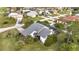 Aerial view of a home with a screened-in pool and mature landscaping at 2462 Albany Dr, Kissimmee, FL 34758