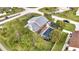 Aerial view of a home with a covered pool surrounded by mature landscaping at 2462 Albany Dr, Kissimmee, FL 34758