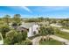 An aerial view of a two-story white home with a gray roof and lush landscaping at 2462 Albany Dr, Kissimmee, FL 34758