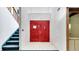 Entryway with red double doors, staircase to the left, and white tile floor at 2462 Albany Dr, Kissimmee, FL 34758