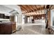 Wide-open living room featuring exposed wooden beams and tile flooring, ready for renovation at 2462 Albany Dr, Kissimmee, FL 34758