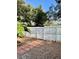 Fenced backyard with red brick pathway and mature landscaping at 2464 Harbour Way, Winter Park, FL 32792