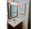 Well-lit bathroom featuring a vanity with storage and a decorative framed mirror at 2464 Harbour Way, Winter Park, FL 32792