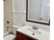 Bathroom featuring a vanity with sink, a toilet, a mirror, a towel rack, and a tiled shower at 2464 Harbour Way, Winter Park, FL 32792