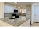 Modern kitchen with stainless steel appliances, granite countertops, and white cabinets at 2464 Harbour Way, Winter Park, FL 32792