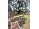 Community walking path with mature trees and a water fountain at 2464 Harbour Way, Winter Park, FL 32792