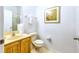 Simple bathroom features a toilet, sink, and mirror at 2725 Coupe St, Kissimmee, FL 34746