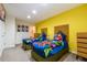 Bright bedroom with two twin beds, closet, and colorful Marvel superhero-themed bedding at 2725 Coupe St, Kissimmee, FL 34746