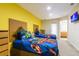 Bright bedroom with two twin beds, closet, and colorful Marvel superhero-themed bedding at 2725 Coupe St, Kissimmee, FL 34746