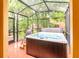 Relaxing enclosed hot tub on a patio surrounded by trees at 2725 Coupe St, Kissimmee, FL 34746