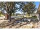 Expansive backyard featuring mature trees, a storage shed, white fencing, and an outdoor seating area at 2938 Foraker Way, Kissimmee, FL 34758