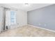 Simple bedroom with tile floors and a window with curtains at 2938 Foraker Way, Kissimmee, FL 34758