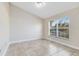 Neutral bedroom featuring tile flooring and a large window offering natural light at 2938 Foraker Way, Kissimmee, FL 34758