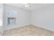 Empty bedroom with neutral walls, tile flooring, and a window at 2938 Foraker Way, Kissimmee, FL 34758