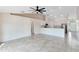 Bright living room flows into kitchen, featuring modern stainless appliances and tile flooring at 2938 Foraker Way, Kissimmee, FL 34758