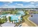 Aerial view of the resort pool with many lounge chairs and palm trees by a small lake at 2980 Caribbean Soul Dr, Kissimmee, FL 34747