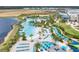 Aerial view of the resort pool with many lounge chairs, palm trees, and resort buildings at 2980 Caribbean Soul Dr, Kissimmee, FL 34747