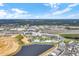 Expansive aerial view of the resort featuring pools, lakes, and colorful homes under a bright blue sky with scattered clouds at 2980 Caribbean Soul Dr, Kissimmee, FL 34747