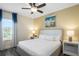 Bright bedroom with large bed, ceiling fan, and natural light from a window at 2980 Caribbean Soul Dr, Kissimmee, FL 34747