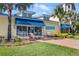 Exterior view of the St. Somewhere Spa, showing the entrance with lounge chairs and tropical landscaping at 2980 Caribbean Soul Dr, Kissimmee, FL 34747