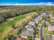 A high-angle view of a neighborhood with houses, golf course and lake at 328 Hamrick Dr, Kissimmee, FL 34759