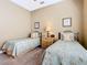 Comfortable bedroom featuring two twin-size beds with decorative bedding, a ceiling fan, and decorative wall art at 328 Hamrick Dr, Kissimmee, FL 34759