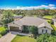 Beautiful single Gathering home with a manicured lawn, paired with a brown garage door and lovely landscaping at 328 Hamrick Dr, Kissimmee, FL 34759