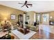 Spacious living room featuring hardwood floors, a ceiling fan, and a neutral color scheme at 328 Hamrick Dr, Kissimmee, FL 34759