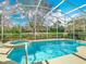 Relaxing screened pool and spa showcasing a lovely private outdoor living space at 328 Hamrick Dr, Kissimmee, FL 34759