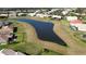 Aerial view of the pond and community featuring green spaces at 4018 Navigator Way, Kissimmee, FL 34746