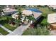 Aerial view of a landscaped property with a tile roof and a view of a pond in the backyard at 4018 Navigator Way, Kissimmee, FL 34746