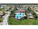 Aerial view of a community pool, clubhouse, and playground surrounded by well-manicured lawns at 4018 Navigator Way, Kissimmee, FL 34746