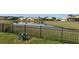 Picturesque pond view of a neighborhood pond from behind a fence on the property at 4018 Navigator Way, Kissimmee, FL 34746