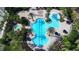 Aerial view of a sparkling swimming pool with plenty of lounge chairs and lush tropical landscaping at 4018 Navigator Way, Kissimmee, FL 34746