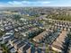 Wide aerial view of the community showcasing many homes, green spaces, and a scenic lake at 430 Novi Path, Kissimmee, FL 34747